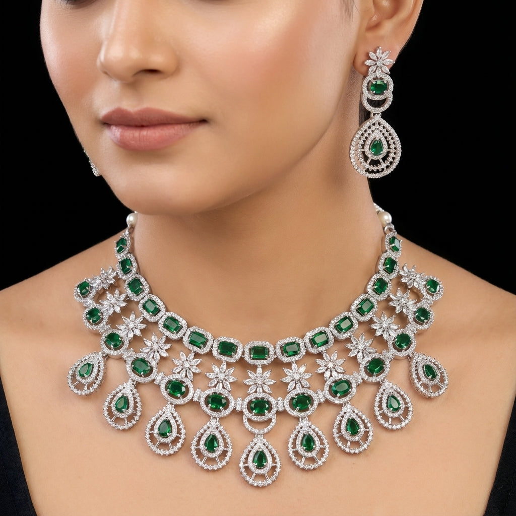 Woman wearing a luxurious emerald and diamond necklace and earrings on a black background