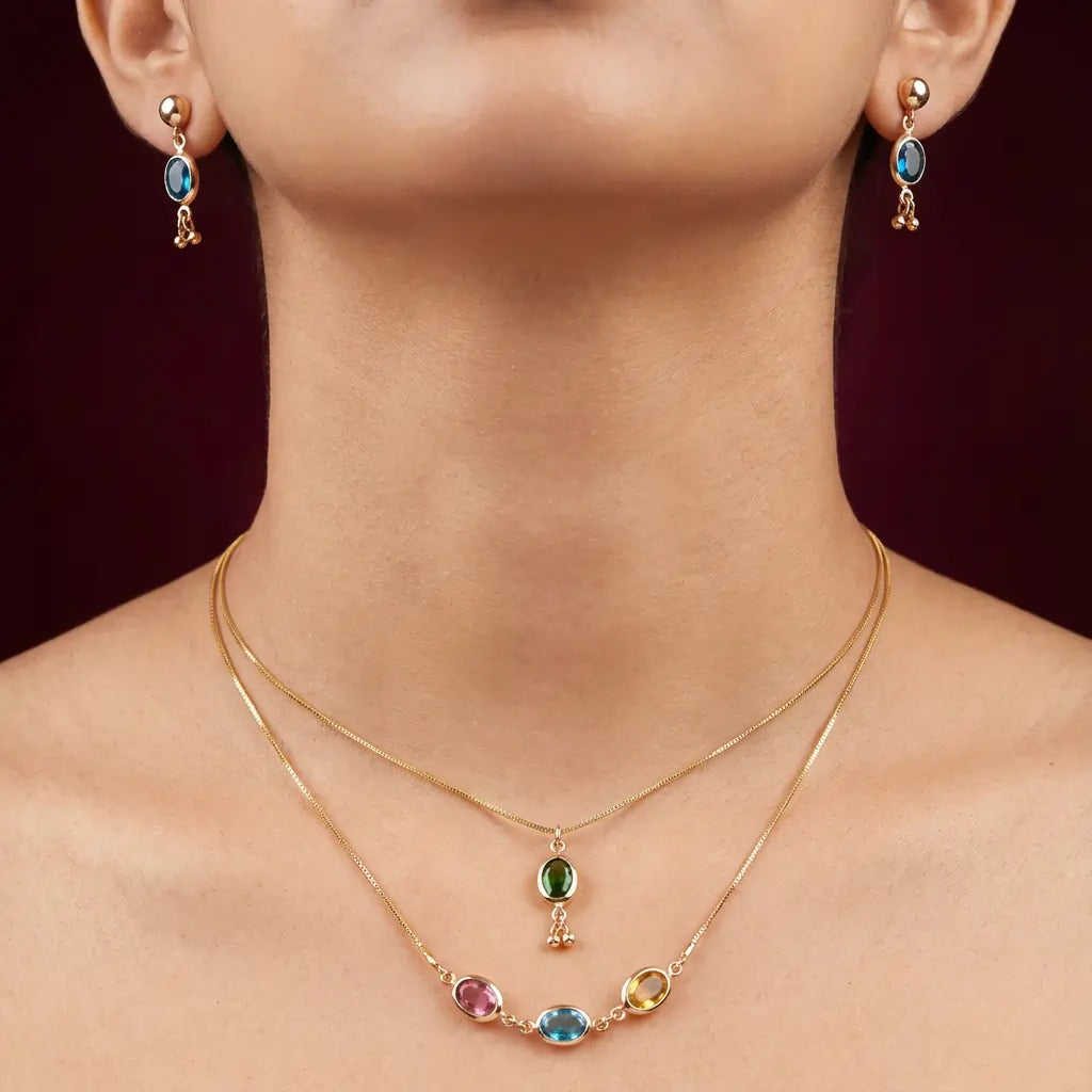 Gold necklace with colorful gemstones worn by a person against a dark background