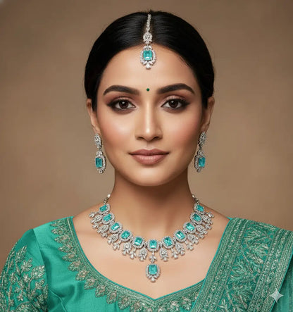 Woman wearing traditional jewelry with a green outfit on a brown background