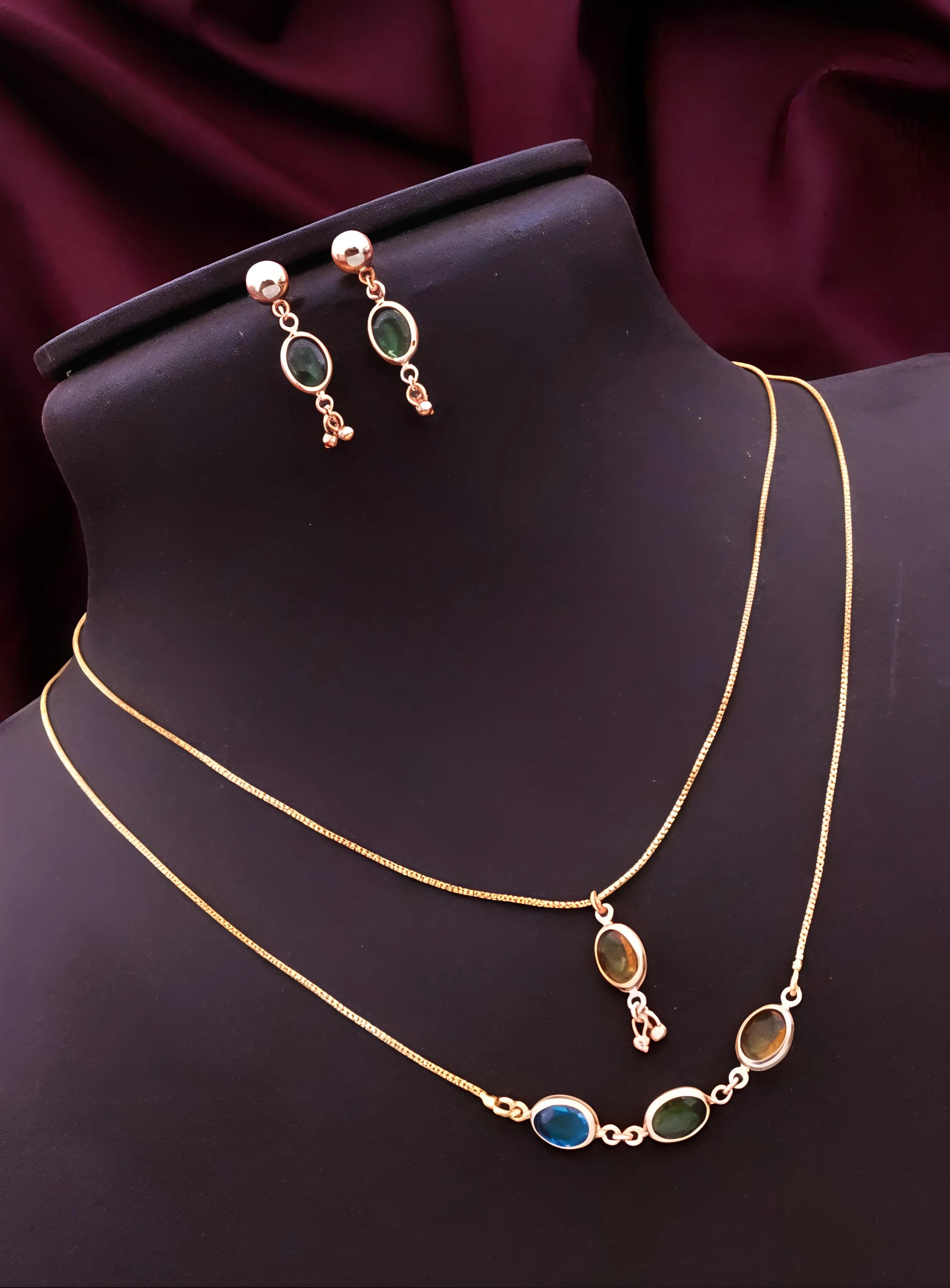 Jewelry set with necklace and earrings on a mannequin bust against a dark background